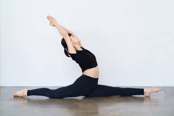 istock Young woman doing yoga indoors 1381016642