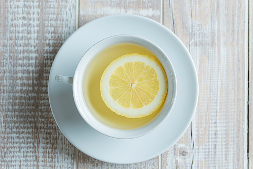 Directly above view of herbal tea with lemon slice.