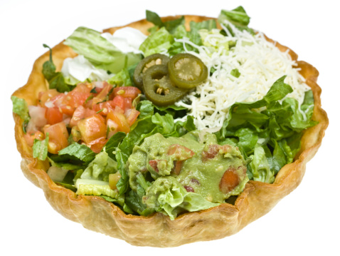 Mexican Tostada Salad in a hard tortilla shell on white background (this picture has been shot with a high definition Hasselblad HD3 II 31 megapixels camera)