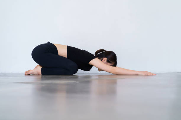 istock Woman doing yoga (child pose) 1381031775