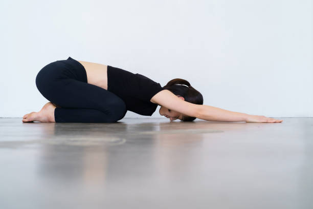 istock Woman doing yoga (child pose) 1381032288