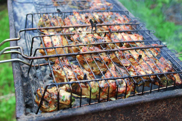 istock Cooking chicken skewers on a roasting pan. Close-up. Background. Top view. 1381037027