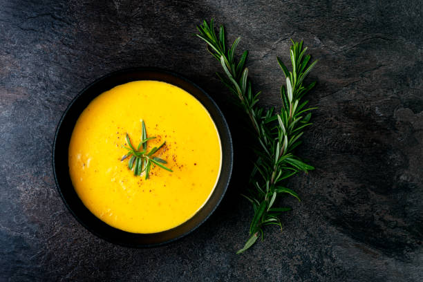 istock Pumpkin soup with linen napkin on dark background. 1381046533