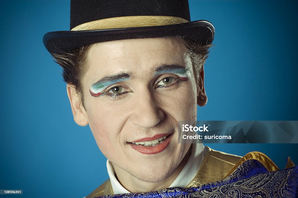 Portrait of the actor Portrait of the actor on a blue background. Portrait in front. Actor in makeup, a blue suit and black hat. Actor Stock Photo