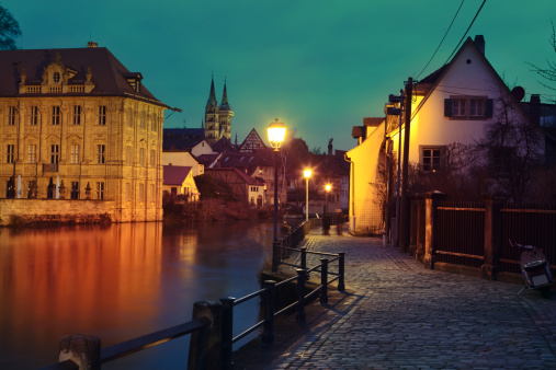 Regnitz quay, Schloss Concordia and Imperial cathedral in evening Bamberg.