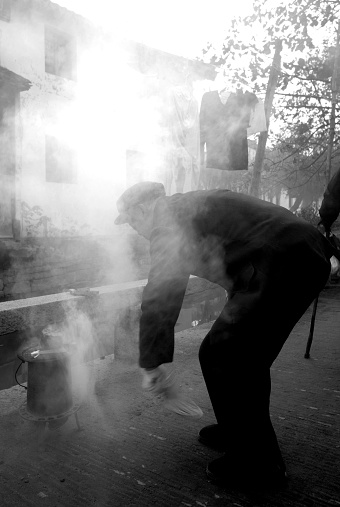 Elderly Chinese man faning his fire, Suzhou, China. Please see more Chinese photos.