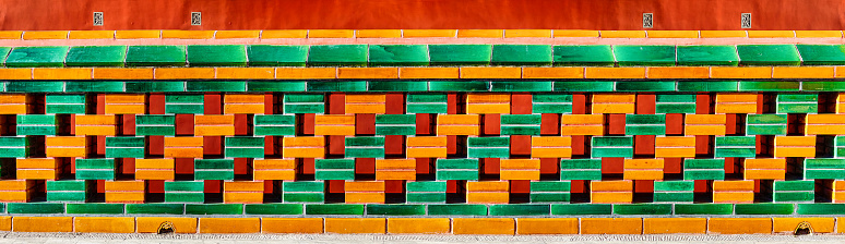 Yellow and green hollow wall, and red background