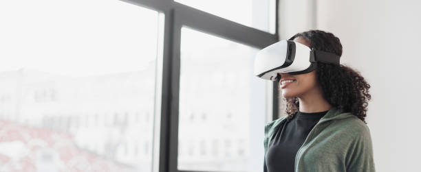 istock Young woman experiencing virtual reality eyeglasses headset 1381098282