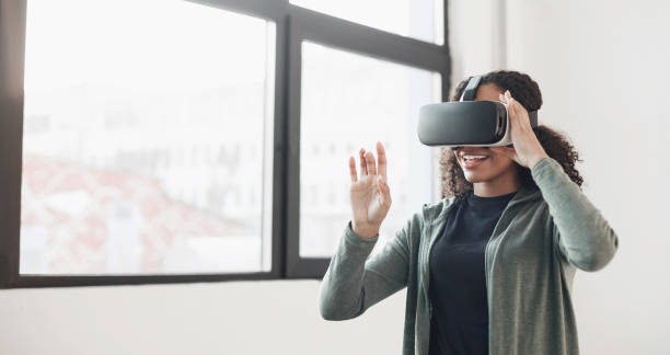 istock Young woman experiencing virtual reality eyeglasses headset 1381098287