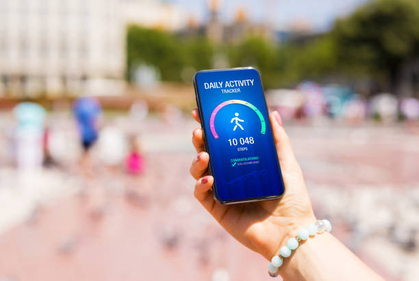 istock Woman using app on phone showing 10 000 steps goal achievement 1381100969