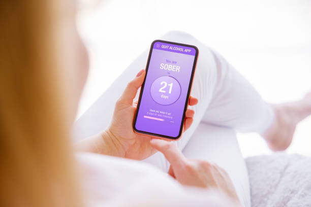istock Woman using mobile app to track alcohol consumption and quit drinking 1381101503