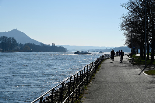 Bonn, March 3, 2022 - Rhine promenade of Bonn / Bad Godesberg with the Drachenfels in the background