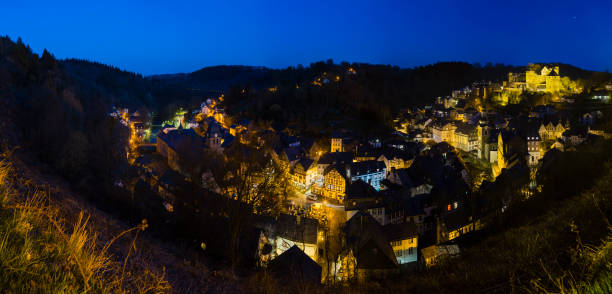 Panoramic view of the beautiful Eifel village Monschau with night blue sky in Germany.