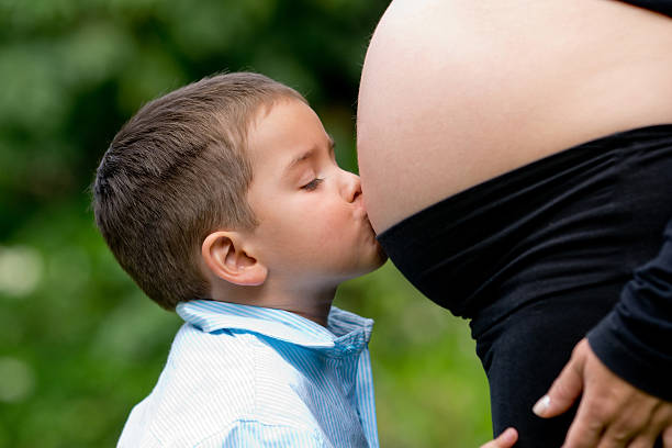 istock Boy kissing pregnant belly 138114641