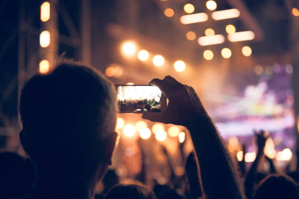 istock Person holding modern smartphone on a concert. 1381165227