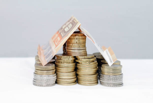 Mortgage, rent, investment - house built out of money stock photo