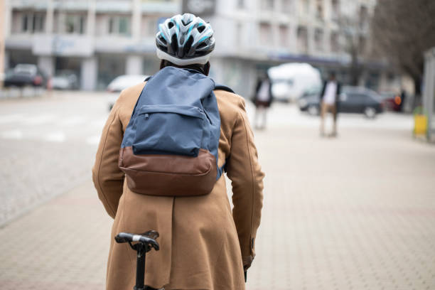 istock The rear view of a man cycling to work wearing a back pack 1381190693