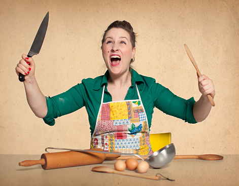 Funny housewife in the kitchen - vintage background