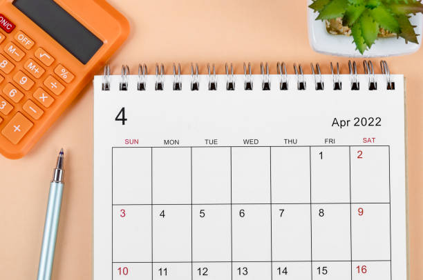 istock April 2022 desk calendar with calculator on beautiful background. 1381219655