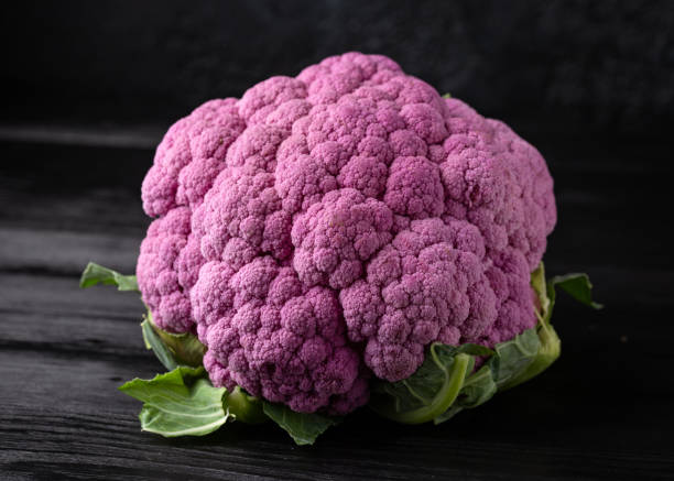 istock Purple colourful cauliflower on black wooden table 1381248889