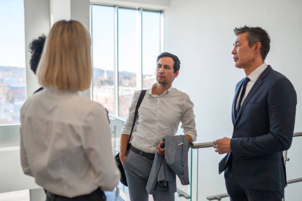 istock Business Professionals Having Discussion In The Office Corridor 1381248938