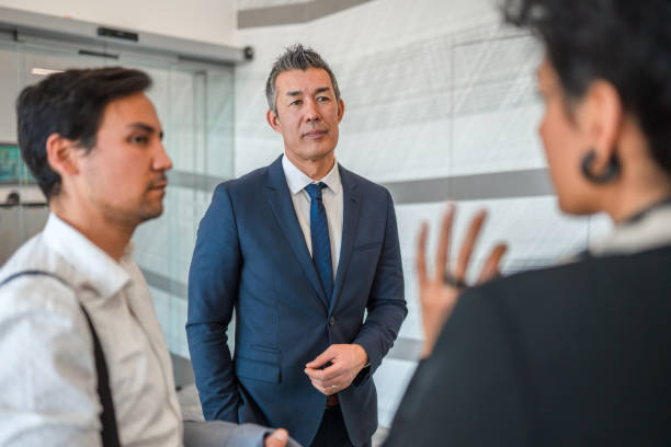 istock Determined Business Coworkers Sharing New Ideas In A Lobby 1381248949