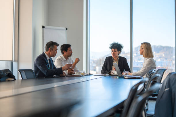 istock A Small Group of Business Colleagues Discussing Plans Around A Conference Table 1381252296