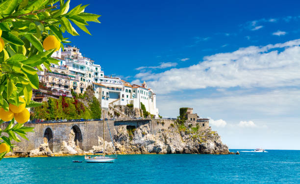 Beautiful view of Amalfi on the Mediterranean coast with lemons in the foreground, Italy Morning view of Amalfi cityscape on coast line of mediterranean sea, Italy amalfi food stock pictures, royalty-free photos & images