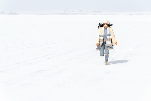 Young Woman having fun in the Snow at Winter