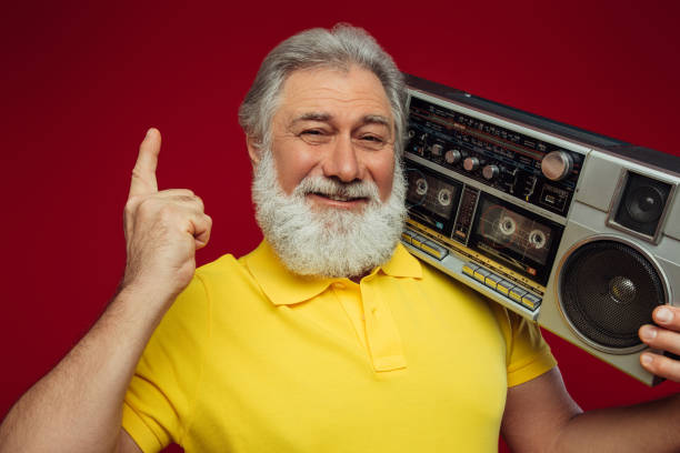 istock Old man holding with cassette boom box enjoying music 1381282316