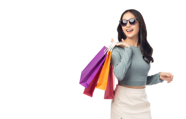 Portrait excited beautiful girl wearing sunglasses holding shopping bags and looking up to copy space Beautiful Asian young woman enjoy shopping isolated over white background Portrait cheerful girl Portrait excited beautiful girl wearing sunglasses holding shopping bags and looking up to copy space Beautiful Asian young woman enjoy shopping isolated over white background Portrait cheerful girl isolated businesswoman isolated on white beauty stock pictures, royalty-free photos & images
