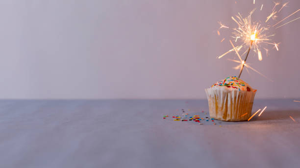 istock Delicious muffin and burning sparkler decorating 1381297598