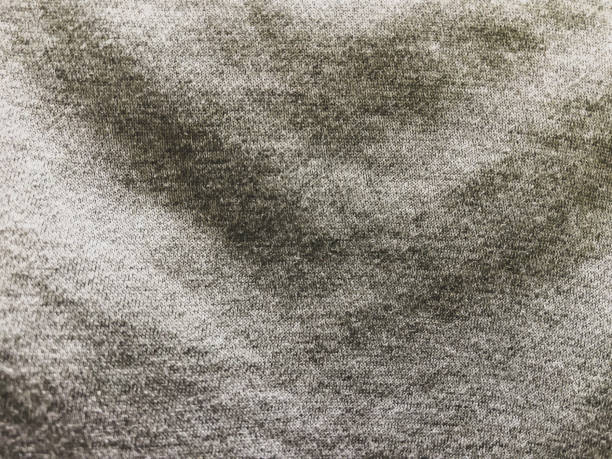 A light gray fabric as a background or texture. A light gray fabric as a background or texture. camel colored stock pictures, royalty-free photos & images