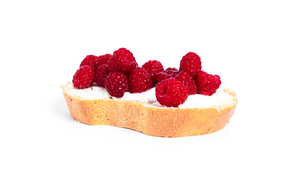 istock Bruschettas with cottage cheese and raspberries isolated on a white background 1381311269