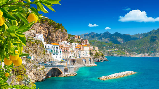Beautiful view of Amalfi on the Mediterranean coast with lemons in the foreground, Italy Morning view of Amalfi cityscape on coast line of mediterranean sea, Italy amalfi food stock pictures, royalty-free photos & images