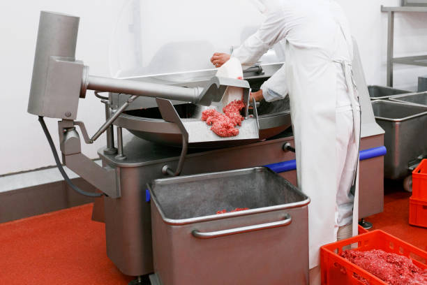 istock A worker at the meat processing factory, adds spices to minced meat in a processing machine. Frame image. 1381320123