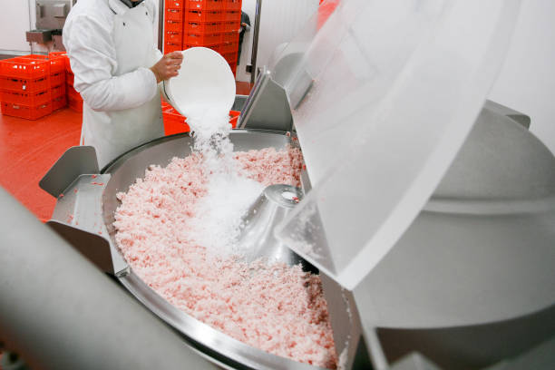 istock A worker at the meat processing factory, adds spices to minced meat in a processing machine. Industry company of meat. 1381320128