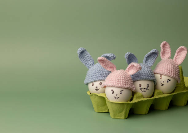 istock Creative composition with Easter bunnies made of eggs and flowers on in craft packaging. 1381320196