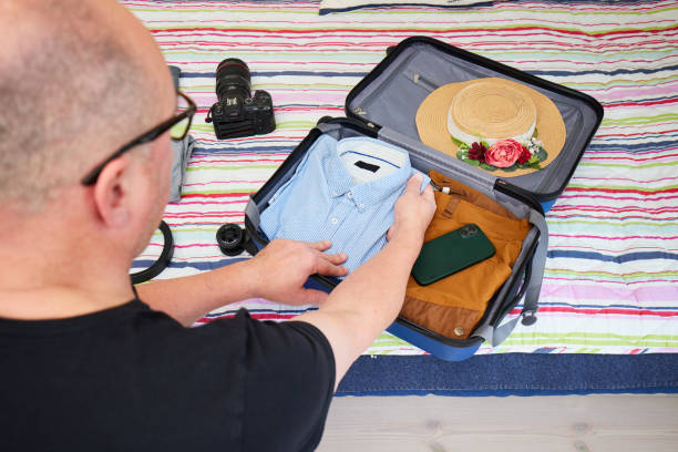 istock Man packing suitcase for travel 1381346935