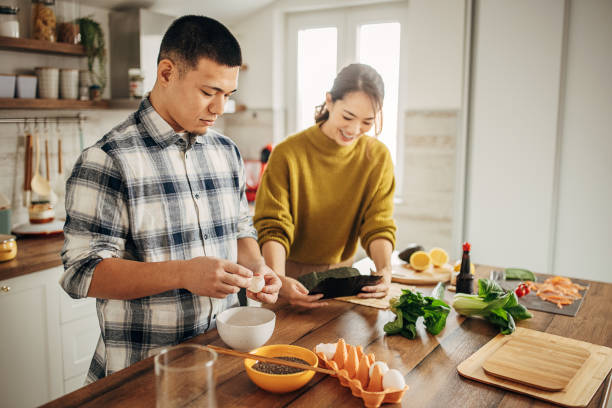 istock Japanese couple preparing sushi 1381354992