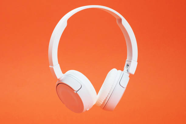 istock Headphones on the orange color background 1381355004
