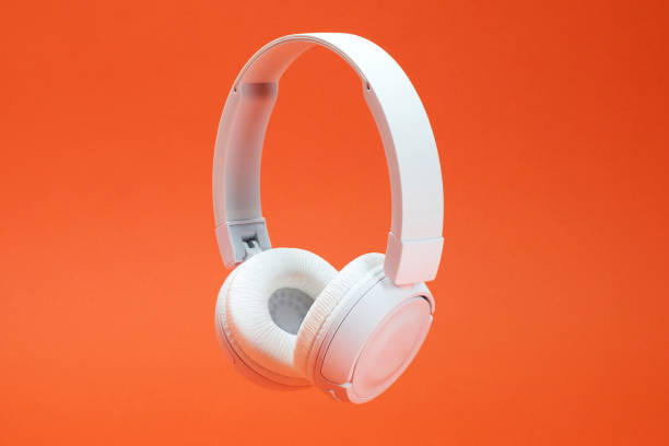Headphones on the orange color background stock photo