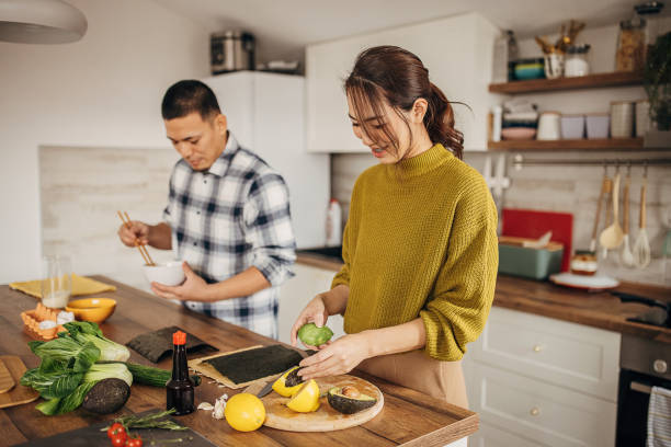 istock Couple preparing sushi 1381357161