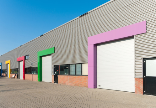 industrial warehouse with roller doors with different color accents