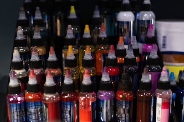 istock Palette of multicoloured tattoo inks. Tattoo salon. Selective focus, blurred. 1381378497