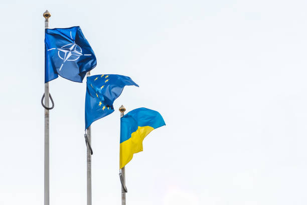 Flag of NATO, European Union and Ukraine Vilnius, Lithuania - February 16 2022: Flag of NATO, European Union and Ukraine waving together in the sky, white copy space for text nato stock pictures, royalty-free photos & images