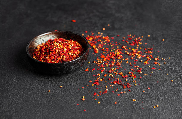 istock Red spices on dark background. Black background 1381406579