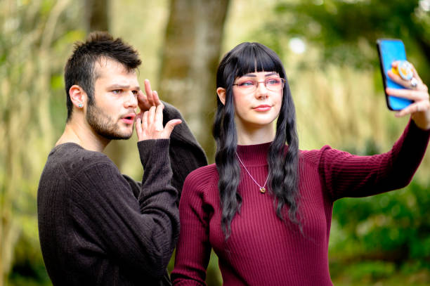 istock Two generation z friends with quirky eccentric style use a cell phone to record a video for TikTok or social media, youth content creation and connectivity 1381408776