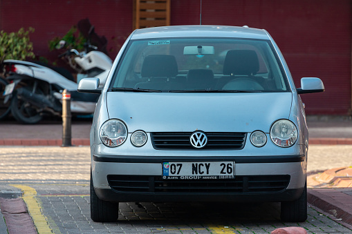 Side, Turkey – February 16 2022: silver Volkswagen Polo is parked  on the street on a warm summer day