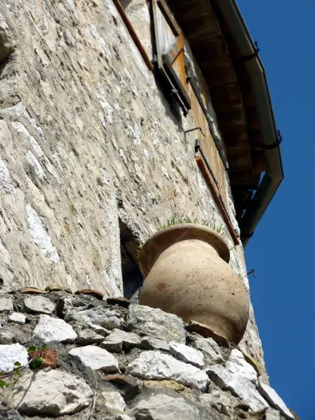 Photo of Brown pottery standing on the wall of a house in Eze historical village, south of France